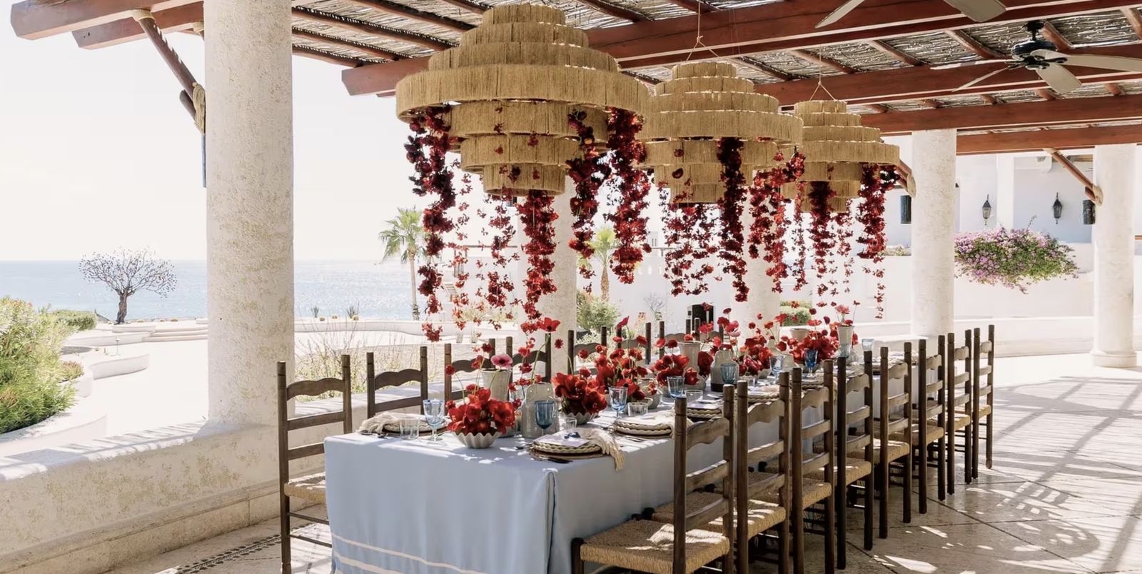A long table under the pergola, looking out to the sea